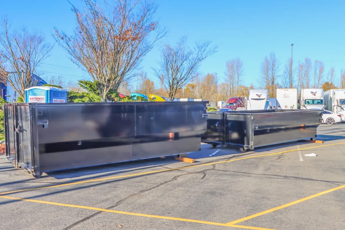 Professional dumpster rental service with roll-off container on residential driveway in Loganville
